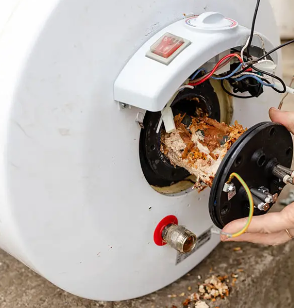 Heavy scale and sediment on a water heater element removed during service