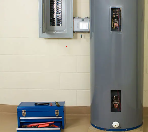 Electric water heater beside an electrical panel with access panels open