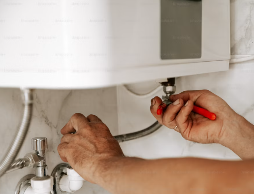 Tightening a water heater supply connection during an urgent repair