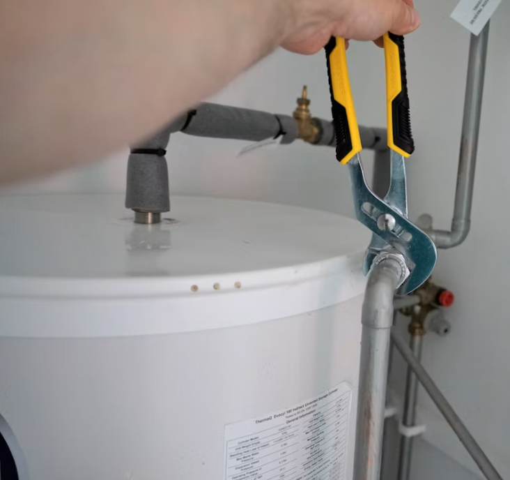 Water heater connections opened up to service the anode rod